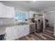 Modern kitchen featuring stainless steel appliances, white cabinets, and updated countertops at 4721 W Iowa Ave, Tampa, FL 33616