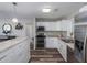 Bright kitchen with white cabinets, modern appliances, and hard surface floors at 4721 W Iowa Ave, Tampa, FL 33616