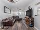 Inviting living room features a comfortable brown sectional and a stylish media center with decor at 4721 W Iowa Ave, Tampa, FL 33616