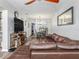 Spacious living room showcasing a brown sectional couch, dining area, and modern decor at 4721 W Iowa Ave, Tampa, FL 33616