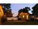 Backyard featuring a well-manicured lawn, string lights, a wooden deck, and patio seating at 4767 6Th N Ave, St Petersburg, FL 33713