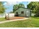 Backyard features wood deck, grill, new green grass, and picket fence at 4767 6Th N Ave, St Petersburg, FL 33713