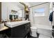 Bathroom featuring a large mirror over a modern vanity, combined shower and tub with elegant fixtures at 4767 6Th N Ave, St Petersburg, FL 33713