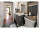 Bathroom featuring a modern vanity with gold fixtures, and a toilet with black wood-paneled wall at 4767 6Th N Ave, St Petersburg, FL 33713