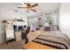 Bedroom with a comfortable bed, desk area, and natural light filtering through sheer curtains at 4767 6Th N Ave, St Petersburg, FL 33713