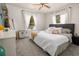 Bedroom with neutral-toned furnishings, large windows with white curtains and a ceiling fan at 4767 6Th N Ave, St Petersburg, FL 33713