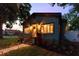 Charming home exterior featuring warm lighting, a welcoming entrance, and lush landscaping at 4767 6Th N Ave, St Petersburg, FL 33713