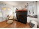 Cozy living room features a decorative fireplace, hardwood floors, and abundant natural light at 4767 6Th N Ave, St Petersburg, FL 33713
