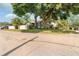Quaint home exterior with mature trees, lush lawn, and a privacy fence at 4767 6Th N Ave, St Petersburg, FL 33713
