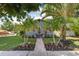 Inviting home showcasing meticulous landscaping with palms and colorful flowers enhancing curb appeal at 4767 6Th N Ave, St Petersburg, FL 33713