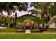 Charming home featuring mature palm trees, meticulous landscaping, and a welcoming front entryway at 4767 6Th N Ave, St Petersburg, FL 33713