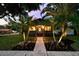 A picturesque home with well-lit palm trees and a walkway leading to a welcoming front door at 4767 6Th N Ave, St Petersburg, FL 33713