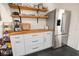 Modern kitchen with stainless steel fridge, butcher block counters, and open shelving at 4767 6Th N Ave, St Petersburg, FL 33713