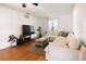 The spacious living room offers a comfortable sectional, hardwood floors, and a bright airy atmosphere at 4767 6Th N Ave, St Petersburg, FL 33713