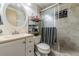 Functional bathroom with a shower, vanity, and neutral tiling at 5004 Suwannee Dr, New Port Richey, FL 34652