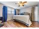 Comfortable bedroom featuring a ceiling fan, natural light, and wood-look floors at 5004 Suwannee Dr, New Port Richey, FL 34652