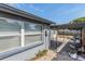 Exterior view showcasing the side of the house with patio and sheds, highlighting its functional outdoor spaces at 5004 Suwannee Dr, New Port Richey, FL 34652