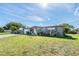 Well-kept home with a vibrant green lawn, front porch, and neatly arranged landscaping enhances its curb appeal at 5004 Suwannee Dr, New Port Richey, FL 34652