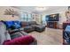 Spacious living room with a large sectional sofa, fireplace, and modern flooring at 5004 Suwannee Dr, New Port Richey, FL 34652
