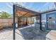 Covered patio area adjacent to the house, offering space for outdoor seating and entertaining with privacy fencing at 5004 Suwannee Dr, New Port Richey, FL 34652