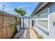 Side yard with a shed and pathway, offering outdoor storage and utility space adjacent to the main building at 5004 Suwannee Dr, New Port Richey, FL 34652