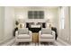 Inviting bedroom with two chairs, a stylish bed, and a cozy, relaxing atmosphere at 5137 Benjamin Eric St, Zephyrhills, FL 33541