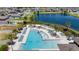 Overhead view of community pool with sun loungers, a beautiful lake, and residential homes at 5208 Dandelion St, Apollo Beach, FL 33572