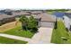An aerial view of a single-Gathering home with a lush lawn, convenient two-car garage, and a serene lake view at 5208 Dandelion St, Apollo Beach, FL 33572
