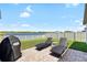 Backyard patio features lounge seating and a scenic pond view at 5208 Dandelion St, Apollo Beach, FL 33572