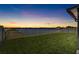 Beautiful backyard overlooking a lake at dusk, providing a tranquil setting for relaxation and enjoyment at 5208 Dandelion St, Apollo Beach, FL 33572