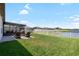 Large backyard features a covered patio and a scenic pond view at 5208 Dandelion St, Apollo Beach, FL 33572