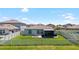 Large backyard with a screened lanai, privacy fence, and well-manicured lawn, perfect for outdoor enjoyment at 5208 Dandelion St, Apollo Beach, FL 33572