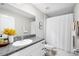 Bathroom vanity features a granite countertop and a shower with curtain at 5208 Dandelion St, Apollo Beach, FL 33572