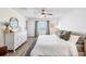 Charming bedroom with a large window providing water views, white dresser, neutral walls, and wood-look floors at 5208 Dandelion St, Apollo Beach, FL 33572