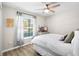 Bedroom with a large window and hardwood floors at 5208 Dandelion St, Apollo Beach, FL 33572