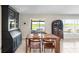 Dining area overlooking the water features a wooden table, two cabinets, and a sliding glass door to the lanai at 5208 Dandelion St, Apollo Beach, FL 33572