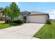 Beautiful single Gathering home featuring a two car garage, manicured lawn, and freshly painted exterior in a desirable neighborhood at 5208 Dandelion St, Apollo Beach, FL 33572