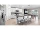 Bright, modern kitchen featuring granite countertops, stainless steel appliances, and a central island with seating at 5208 Dandelion St, Apollo Beach, FL 33572