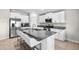 Modern kitchen with island offers stainless appliances, granite countertops, and a breakfast bar with seating at 5208 Dandelion St, Apollo Beach, FL 33572
