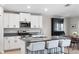 Stylish kitchen with granite countertops, stainless appliances, white cabinets, and an island offers seating at 5208 Dandelion St, Apollo Beach, FL 33572