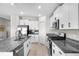 Bright kitchen with stainless steel appliances, granite countertops, and white cabinetry provides ample space for cooking at 5208 Dandelion St, Apollo Beach, FL 33572