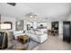 Open-concept living space with a spacious sofa, modern decor, and a seamless flow to the kitchen area at 5208 Dandelion St, Apollo Beach, FL 33572