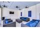 Inviting outdoor lounge area with comfortable seating, ceiling fans, and a mounted TV for relaxation at 5208 Dandelion St, Apollo Beach, FL 33572