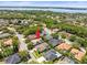 Overhead shot of home nestled amongst mature trees in a quiet neighborhood at 5216 Kernwood Ct, Palm Harbor, FL 34685