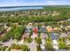 Expansive aerial view of neighborhood with mature trees, and lake views at 5216 Kernwood Ct, Palm Harbor, FL 34685