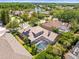 Aerial shot of the backyard pool and patio, with a view of the neighborhood and a nearby lake at 5216 Kernwood Ct, Palm Harbor, FL 34685