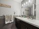 Elegant bathroom featuring a double sink vanity with dark wood cabinets and stylish decorative accents at 5216 Kernwood Ct, Palm Harbor, FL 34685