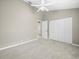 Spacious bedroom featuring a ceiling fan and neutral carpeting at 5216 Kernwood Ct, Palm Harbor, FL 34685