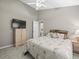 Bedroom featuring ceiling fan, neutral carpeting, and access to home at 5216 Kernwood Ct, Palm Harbor, FL 34685
