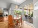 Breakfast nook featuring an oval table and sliding glass doors to outdoor patio with pool views at 5216 Kernwood Ct, Palm Harbor, FL 34685